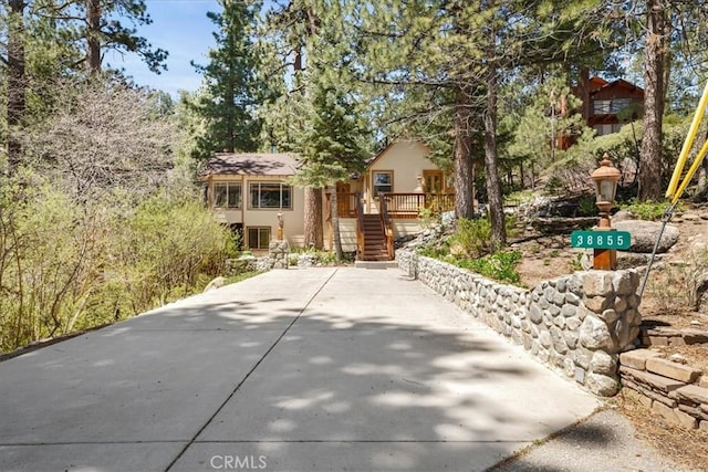 38855 Big Bear Blvd, Big Bear Lake, CA 92315 - view of front of home with stairs, stucco siding, and a deck