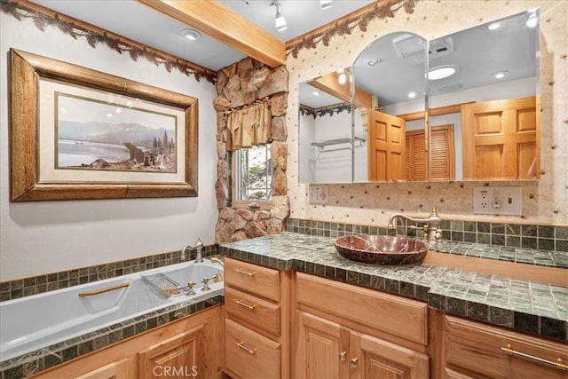 38855 Big Bear Blvd, Big Bear Lake, CA 92315 - bathroom featuring a bath, vanity, and decorative backsplash
