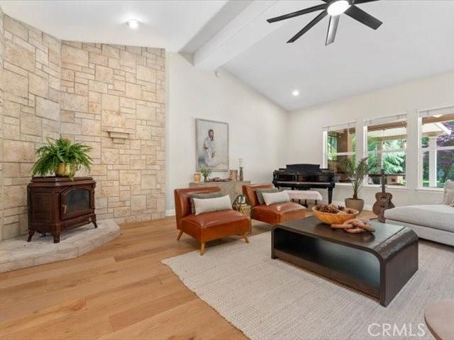 25179 68th Ave, Los Molinos, CA 96055 - living area featuring a ceiling fan, wood finished floors, and a wood stove