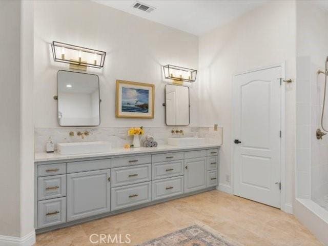 25179 68th Ave, Los Molinos, CA 96055 - bathroom with double vanity, a tile shower, and decorative backsplash
