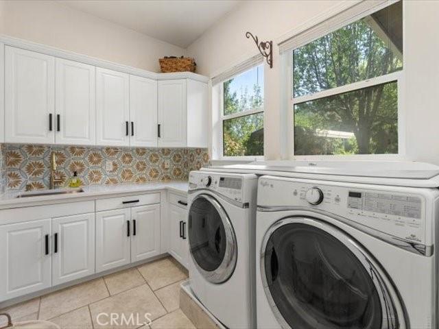 25179 68th Ave, Los Molinos, CA 96055 - clothes washing area with washer and dryer, cabinet space, and light tile patterned floors