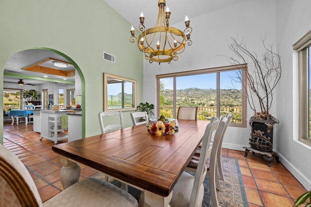 979 Canyon Heights Rd, Fallbrook, CA 92028 - dining space with arched walkways, healthy amount of natural light, a chandelier, baseboards, and a high ceiling