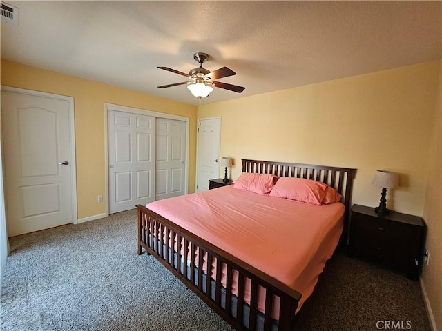 bedroom featuring carpet floors, a closet, baseboards, and a ceiling fan