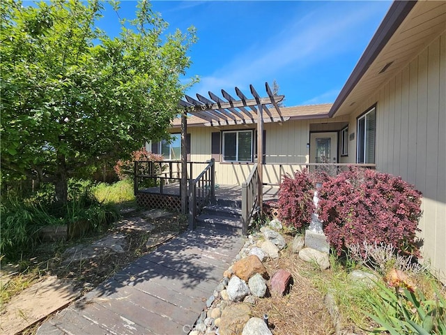view of front of home featuring a pergola and a wooden deck