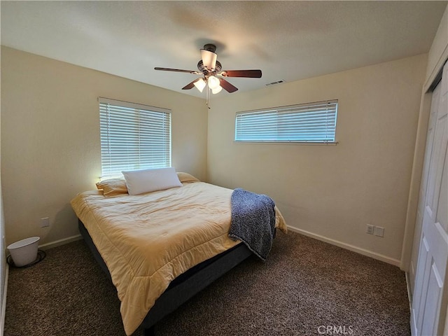 carpeted bedroom with baseboards and a ceiling fan