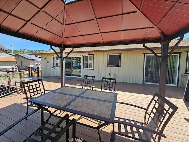 deck featuring a gazebo and outdoor dining space