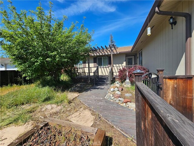 back of property with fence and a pergola