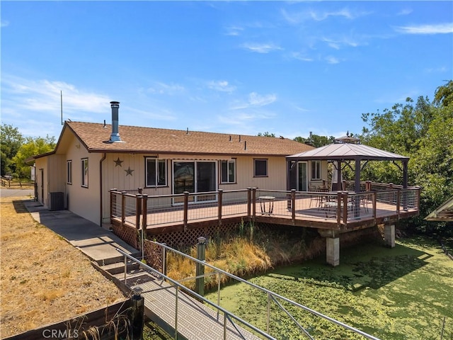 12855 Island Cir, Clearlake Oaks, CA 95423 - back of house featuring a gazebo, a wooden deck, a shingled roof, and a lawn