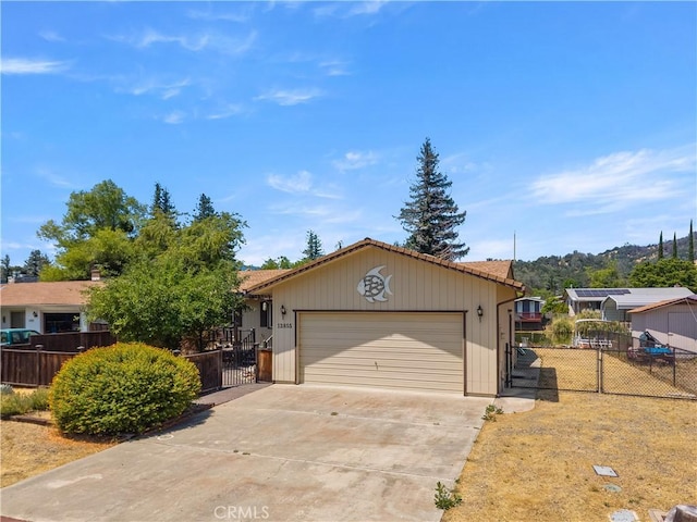 12855 Island Cir, Clearlake Oaks, CA 95423 - single story home with a gate, an attached garage, and driveway