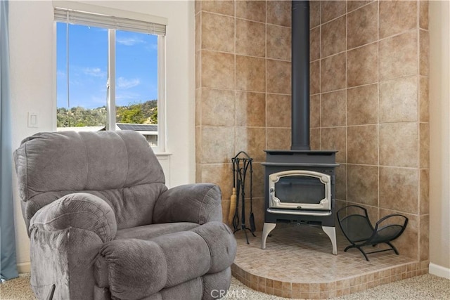 12855 Island Cir, Clearlake Oaks, CA 95423 - sitting room with a wood stove and carpet floors