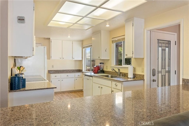 12855 Island Cir, Clearlake Oaks, CA 95423 - kitchen with white appliances, light wood-type flooring, white cabinets, recessed lighting, and dark stone countertops
