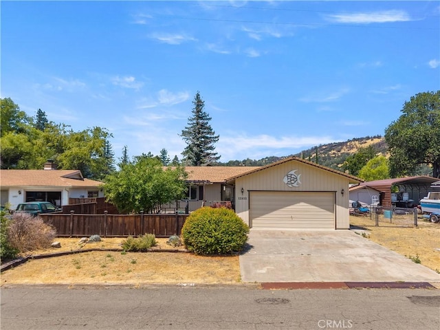 12855 Island Cir, Clearlake Oaks, CA 95423 - ranch-style home with a garage and driveway