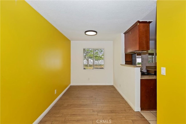 4286 N 4th Ave, San Bernardino, CA 92407 - hall with a textured ceiling, light wood-style floors, and baseboards