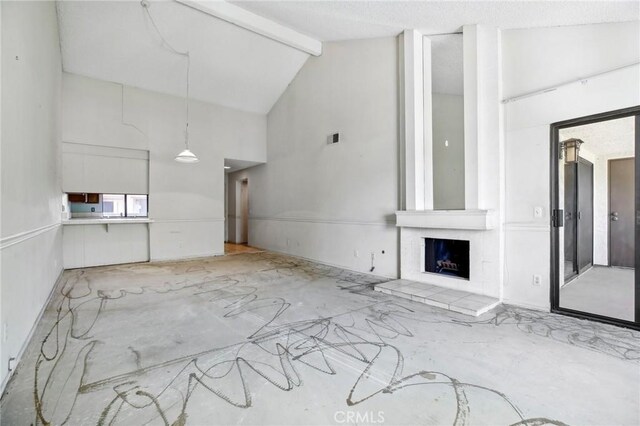 2506 E Willow St Unit 302, Signal Hill, CA 90755 - unfurnished living room featuring high vaulted ceiling, beamed ceiling, and a fireplace