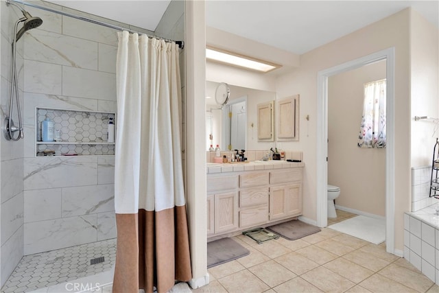 7138 Amanda Way, Hesperia, CA 92345 - bathroom featuring a tile shower, toilet, vanity, tile patterned flooring, and baseboards
