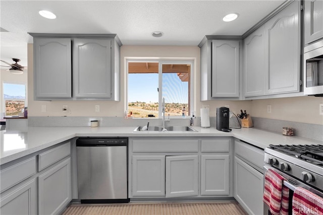 7138 Amanda Way, Hesperia, CA 92345 - kitchen featuring appliances with stainless steel finishes, a sink, light countertops, recessed lighting, and gray cabinetry