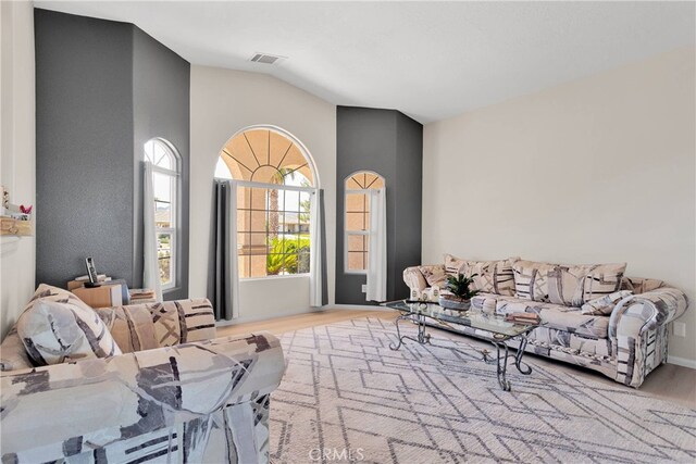 7138 Amanda Way, Hesperia, CA 92345 - living area featuring wood finished floors, vaulted ceiling, and baseboards