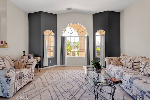 7138 Amanda Way, Hesperia, CA 92345 - living room featuring vaulted ceiling, light wood finished floors, and baseboards