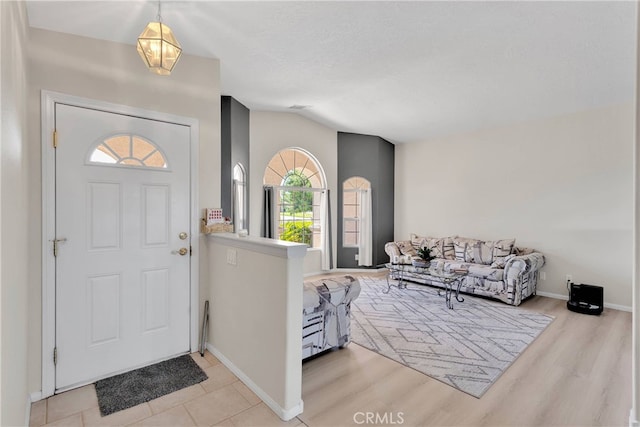 7138 Amanda Way, Hesperia, CA 92345 - foyer featuring baseboards, light wood finished floors, and vaulted ceiling