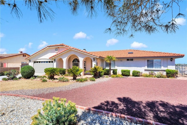 7138 Amanda Way, Hesperia, CA 92345 - mediterranean / spanish-style house with stucco siding, a tile roof, an attached garage, fence, and driveway