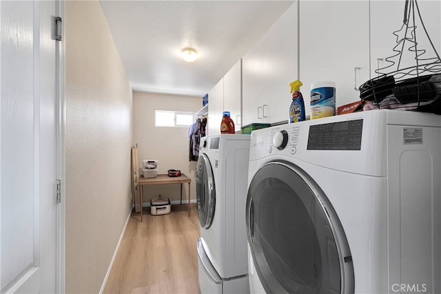 7138 Amanda Way, Hesperia, CA 92345 - clothes washing area featuring cabinet space, light wood-style flooring, washer and clothes dryer, and baseboards
