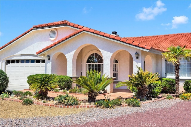 7138 Amanda Way, Hesperia, CA 92345 - mediterranean / spanish house with a tiled roof, stucco siding, and an attached garage
