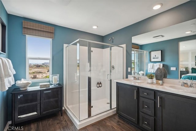 14063 Starlene St, Moreno Valley, CA 92555 - bathroom featuring a stall shower, ensuite bathroom, wood finished floors, and double vanity