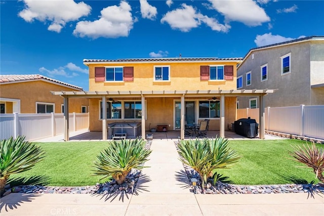 1357 Bannock St, Beaumont, CA 92223 - back of house featuring a hot tub, stucco siding, ceiling fan, a pergola, and a patio