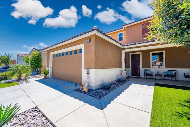 1357 Bannock St, Beaumont, CA 92223 - mediterranean / spanish-style home featuring stucco siding, a garage, covered porch, and driveway
