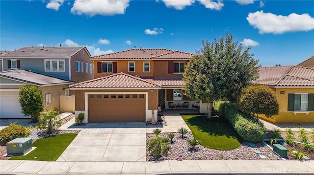 1357 Bannock St, Beaumont, CA 92223 - view of front of house with stucco siding, a garage, a tiled roof, concrete driveway, and covered porch
