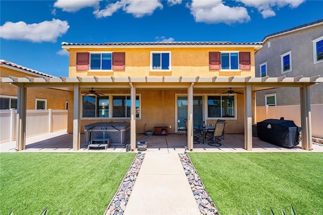 1357 Bannock St, Beaumont, CA 92223 - back of property featuring a hot tub, a ceiling fan, stucco siding, and a patio area