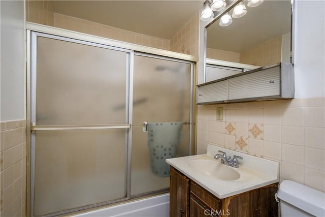 3320 Opal St, Los Angeles, CA 90023 - bathroom featuring tile walls, toilet, vanity, and combined bath / shower with glass door