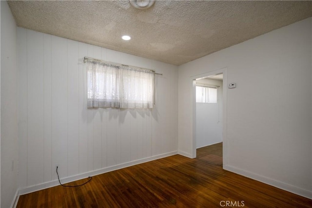 3320 Opal St, Los Angeles, CA 90023 - spare room featuring dark wood finished floors, a textured ceiling, and baseboards