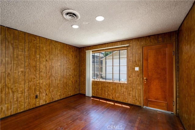 3320 Opal St, Los Angeles, CA 90023 - spare room with wood finished floors, a textured ceiling, and wood walls
