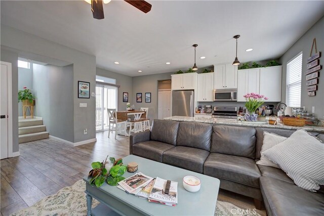 594 Rockaway Ave Unit B, Grover Beach, CA 93433 - living room featuring light wood-type flooring, ceiling fan, stairway, recessed lighting, and baseboards