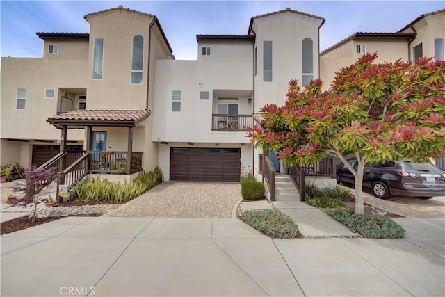594 Rockaway Ave Unit B, Grover Beach, CA 93433 - view of front of property featuring stucco siding, a tile roof, a garage, and decorative driveway