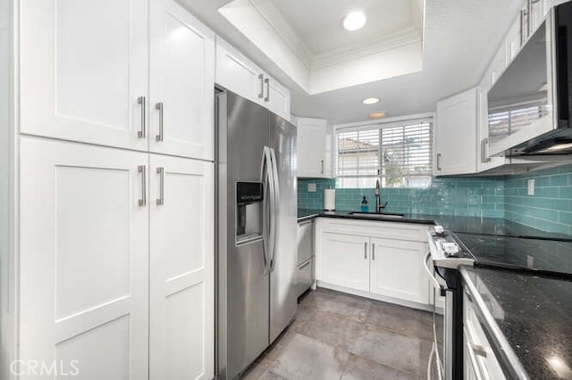 23391 La Crescenta Unit 270C, Mission Viejo, CA 92691 - kitchen featuring stainless steel appliances, a raised ceiling, ornamental molding, tasteful backsplash, and white cabinetry