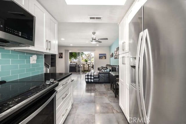 23391 La Crescenta Unit 270C, Mission Viejo, CA 92691 - kitchen featuring stainless steel fridge, ceiling fan, white cabinetry, tasteful backsplash, and range with electric cooktop
