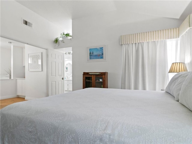 24822 Cutter, Laguna Niguel, CA 92677 - bedroom with wood finished floors, vaulted ceiling, baseboards, and ensuite bathroom