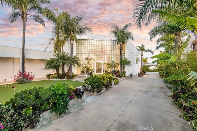20301 SW Cypress St, Newport Beach, CA 92660 - view of front facade featuring an area to practice putting and stucco siding
