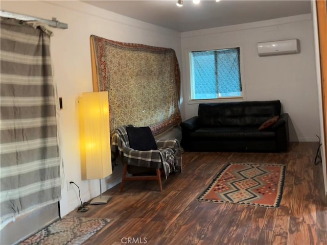 3940 Morongo Rd Unit 29, Palms, CA 92277 - sitting room featuring a wall unit AC and wood finished floors