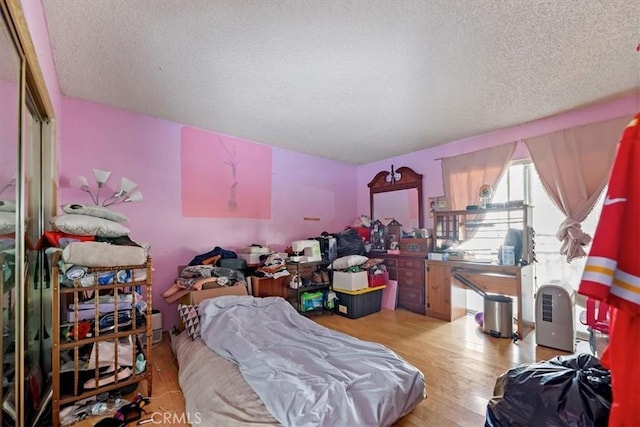 435 Leverett Ave, La Puente, CA 91744 - bedroom featuring a textured ceiling, light wood-type flooring, and a closet