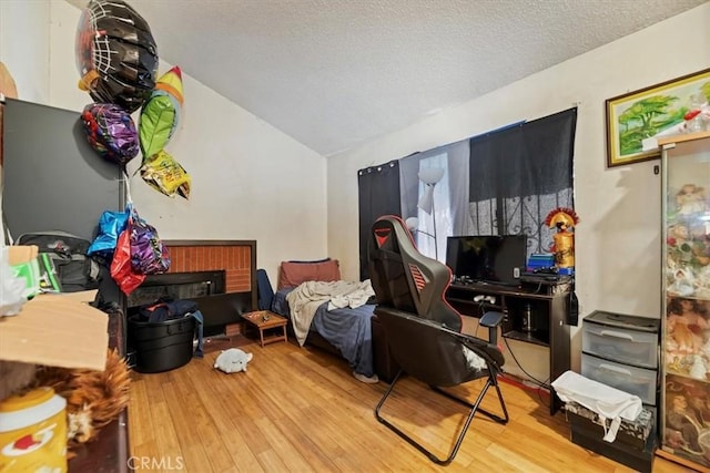 435 Leverett Ave, La Puente, CA 91744 - sitting room with wood finished floors, vaulted ceiling, and a textured ceiling