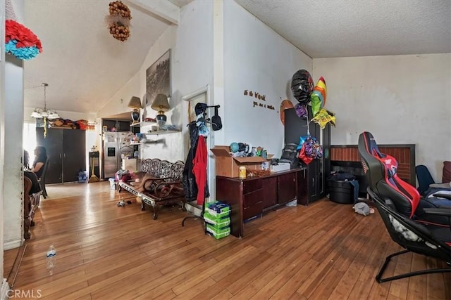 435 Leverett Ave, La Puente, CA 91744 - living room featuring wood-type flooring, lofted ceiling, and a textured ceiling