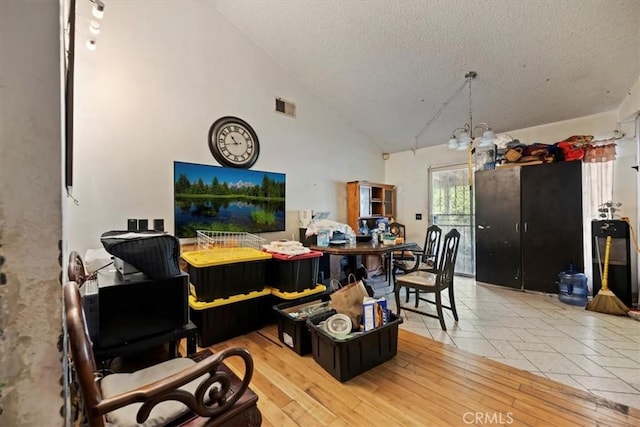 435 Leverett Ave, La Puente, CA 91744 - dining area featuring a textured ceiling and high vaulted ceiling