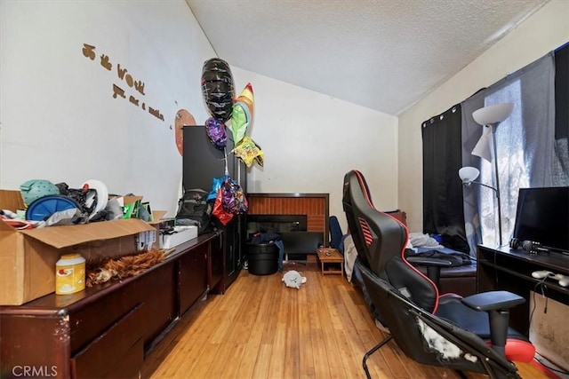 435 Leverett Ave, La Puente, CA 91744 - office with light wood-style flooring, lofted ceiling, and a textured ceiling