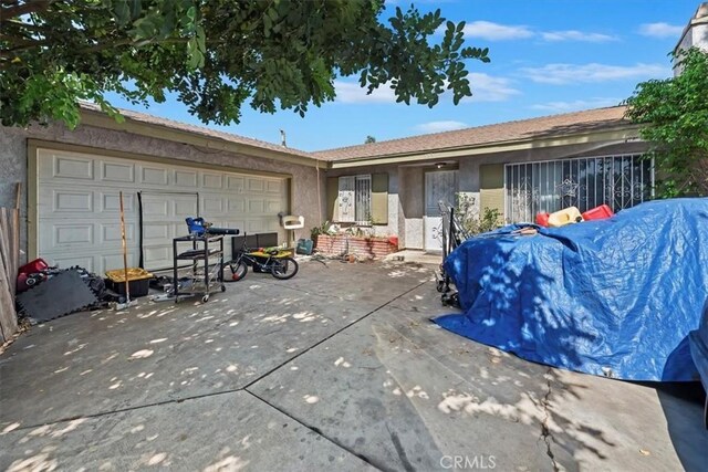 435 Leverett Ave, La Puente, CA 91744 - back of house featuring stucco siding and an attached garage