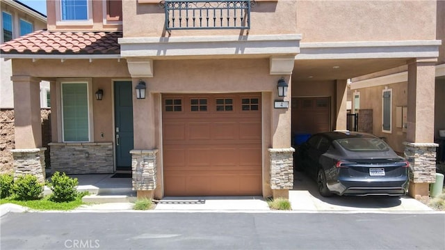 15148 Ridge Ln Unit 4, Fontana, CA 92336 - property entrance with a garage, stucco siding, stone siding, and a tiled roof
