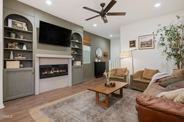 345 Allen Dr, Santa Paula, CA 93060 - living room featuring wood finished floors, a ceiling fan, a glass covered fireplace, recessed lighting, and built in features