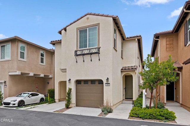345 Allen Dr, Santa Paula, CA 93060 - view of front of property with a tiled roof, a garage, stucco siding, and driveway